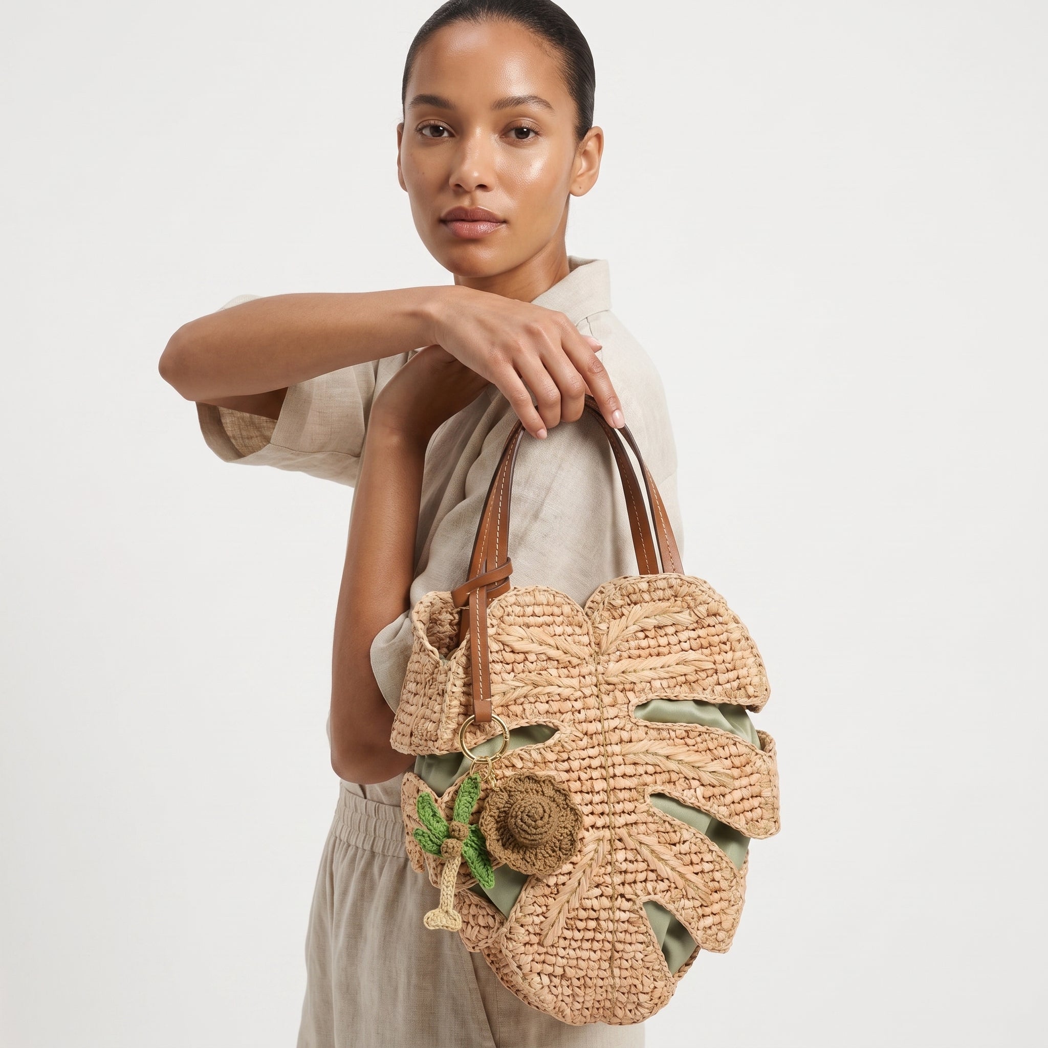 Handmade raffia palm leaf tote bag model closeup
