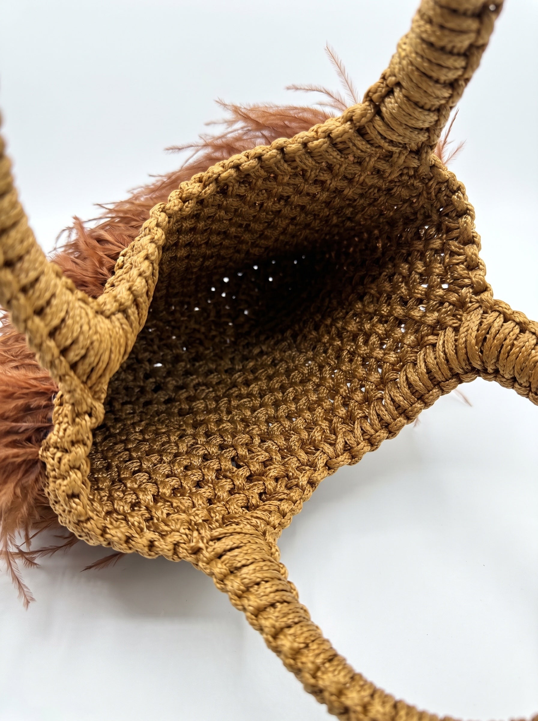 Interior detail of handcrafted macrame feather bag