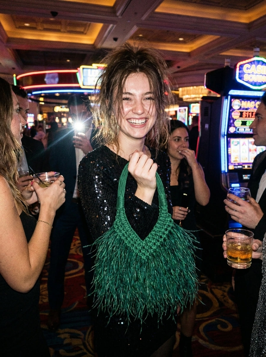 Emerald green feather bag styled for an evening party
