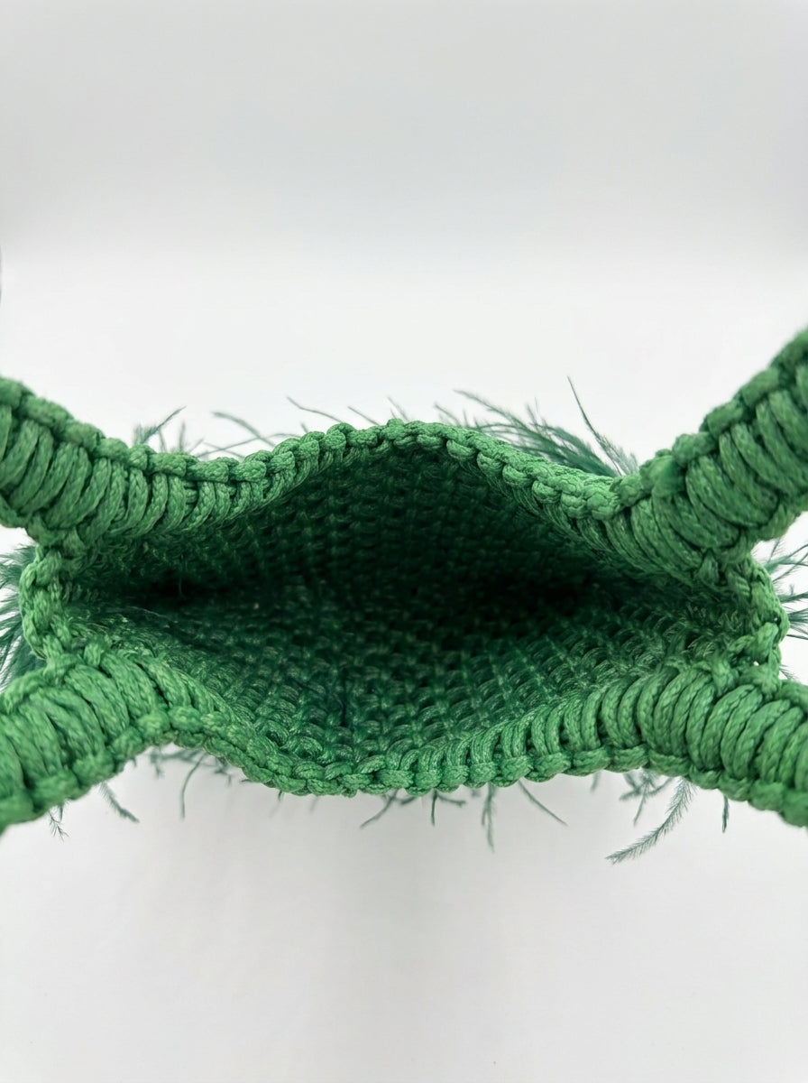 Interior detail of handcrafted green macrame feather bag